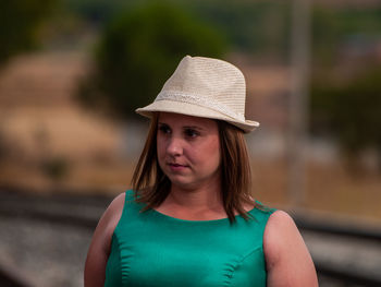 Beautiful overweight woman standing at railroad track