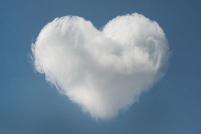 Low angle view of heart shape against blue sky