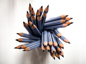 Close-up of multi colored pencils against white background