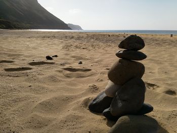 Rocks on beach against sky