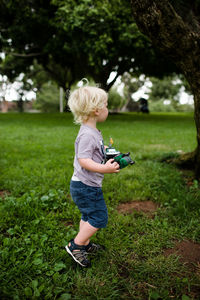 Full length of boy climbing on tree