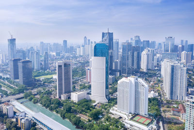 High angle view of modern buildings in city against sky