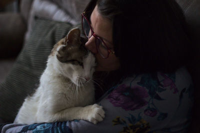 Young woman with cat at home