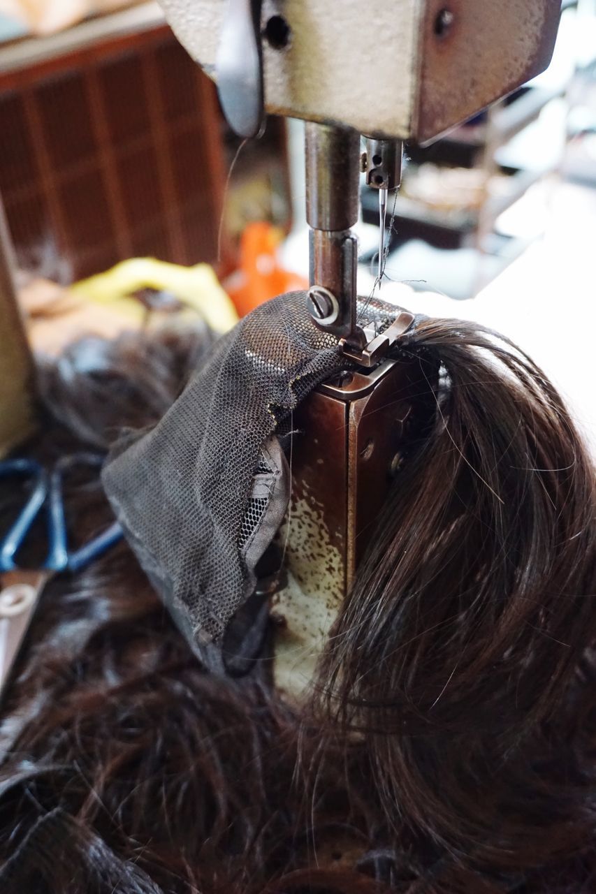 HIGH ANGLE VIEW OF CHILD HANGING FROM METAL