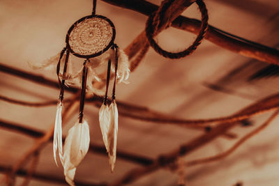 Dreamcatcher hanging in boho beige interior in the evening light. magical and ritual ornament