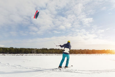 Full length of man skiing on snow covered landscape