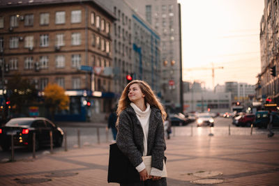 Woman standing on city street