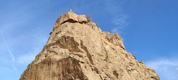 Low angle view of rock formation against sky