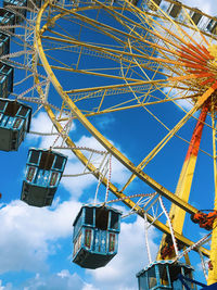 Low angle view of ferris wheel against sky
