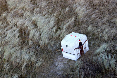 High angle view of hooded beach chairs on field