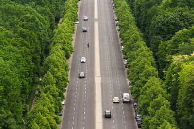 High angle view of vehicles on road amidst trees