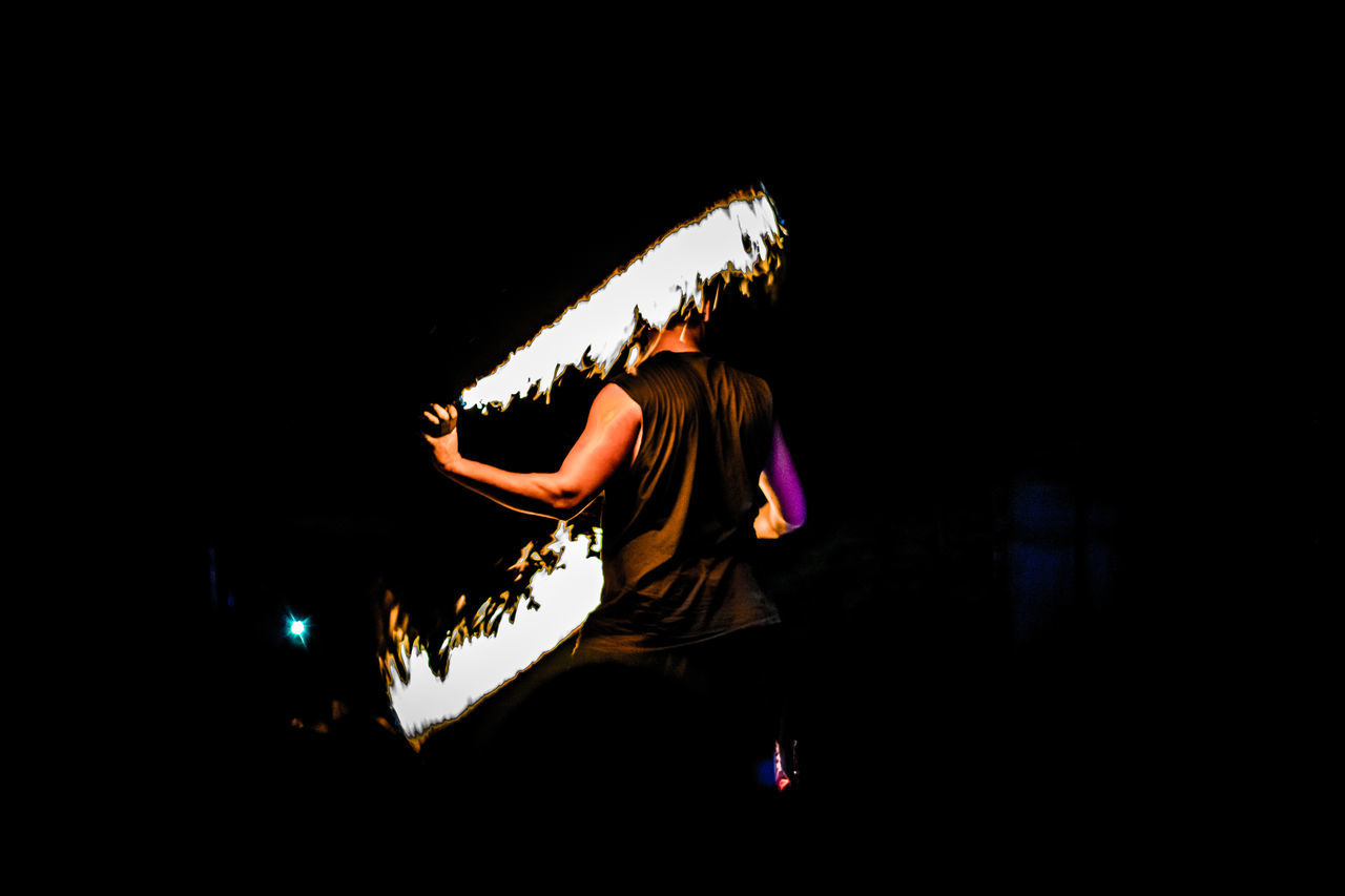 REAR VIEW OF A MAN WITH UMBRELLA