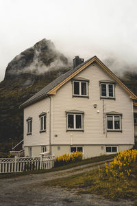 House by building against sky