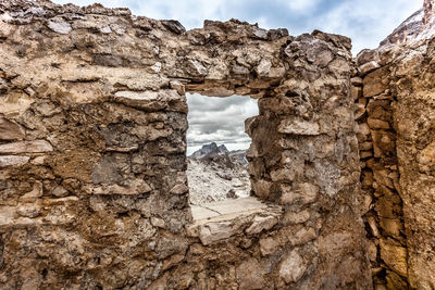 Low angle view of rock formation against sky