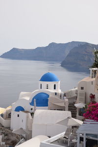 View of sea and buildings against sky