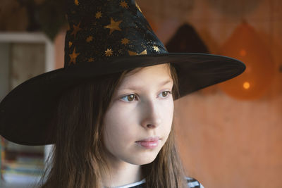 Halloween. sad pensive girl in witch costume celebrating halloween. unhappy teen girl