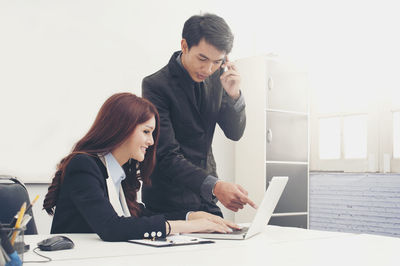 Young woman using laptop on table