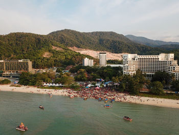 High angle view of buildings by sea against sky