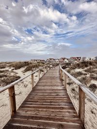 Pier over sea against sky