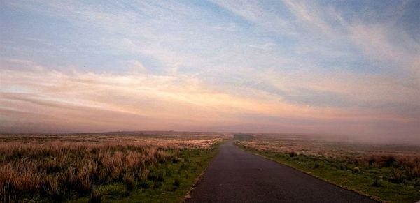 Road passing through field