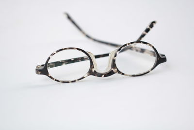 Close-up of sunglasses against white background