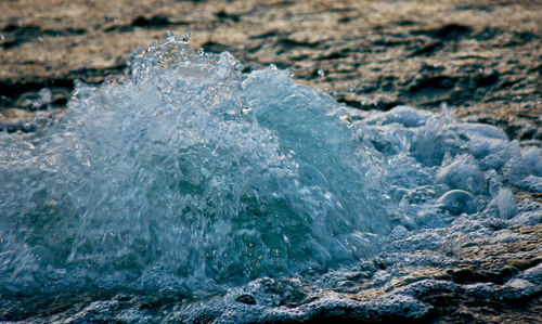 Close-up of sea waves splashing on rocks