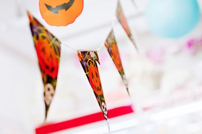Close-up of multi colored decorations hanging from ceiling during halloween