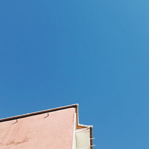 Low angle view of building against clear blue sky