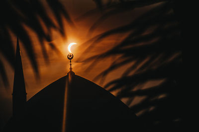 High section of mosque against the moon