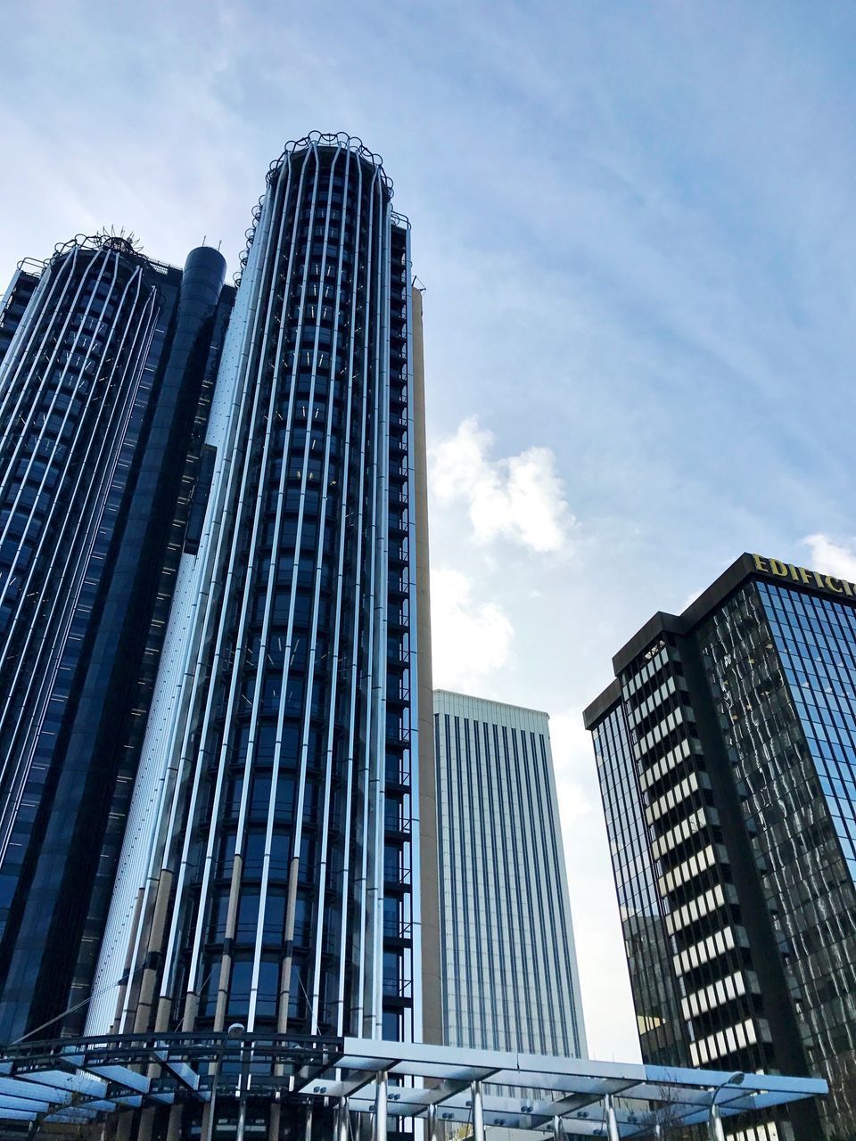 LOW ANGLE VIEW OF MODERN SKYSCRAPERS AGAINST SKY