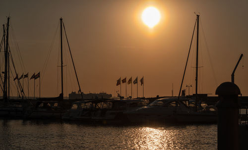 Sailboats in marina at sunset