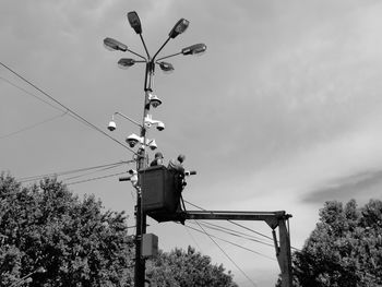 Low angle view of telephone pole against sky