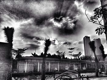 Low angle view of buildings against cloudy sky