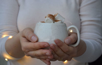 Midsection of woman holding gift