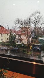 Buildings seen through wet window during rainy season