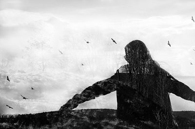 Multiple exposure of silhouette man with trees in forest