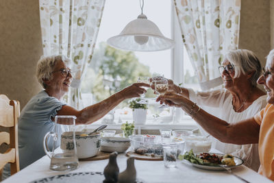 Smiling senior woman having toast during meal