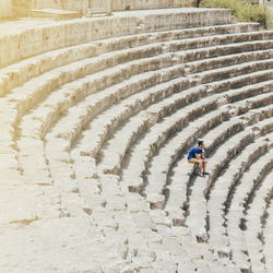 High angle view of man sitting at roman theater