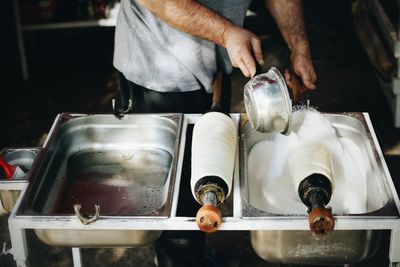 Midsection of man preparing food