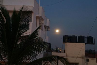 Low angle view of buildings against sky at sunset