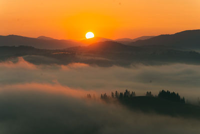 Scenic view of a panorama of a mountain slope with a fog and a haze in ukraine, carpathians.