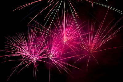 Low angle view of firework display at night