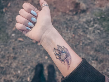 Close-up of woman hand with paw tattoo