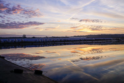 Scenic view of sea against dramatic sky during sunset