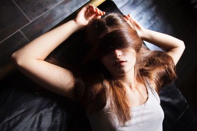 High angle view of young woman sleeping on bed at home