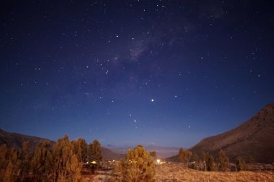 Scenic view of field against sky at night