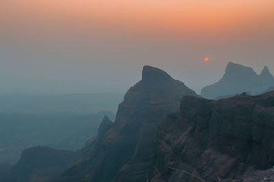 Scenic view of mountains against sky during sunset