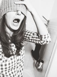 Portrait of smiling young woman standing in bathroom