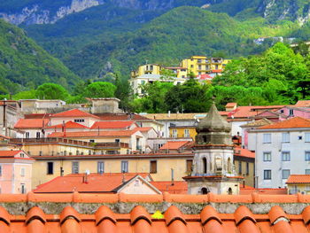 Houses in city against mountains