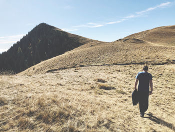 Rear view of man walking on land